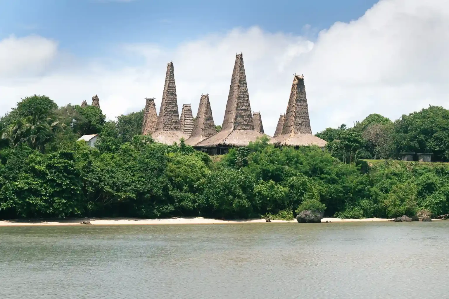 Tower-roof uma houses and stone tombs in a Sumba traditional village, the same architecture family found at Prai Ijing village Sumba